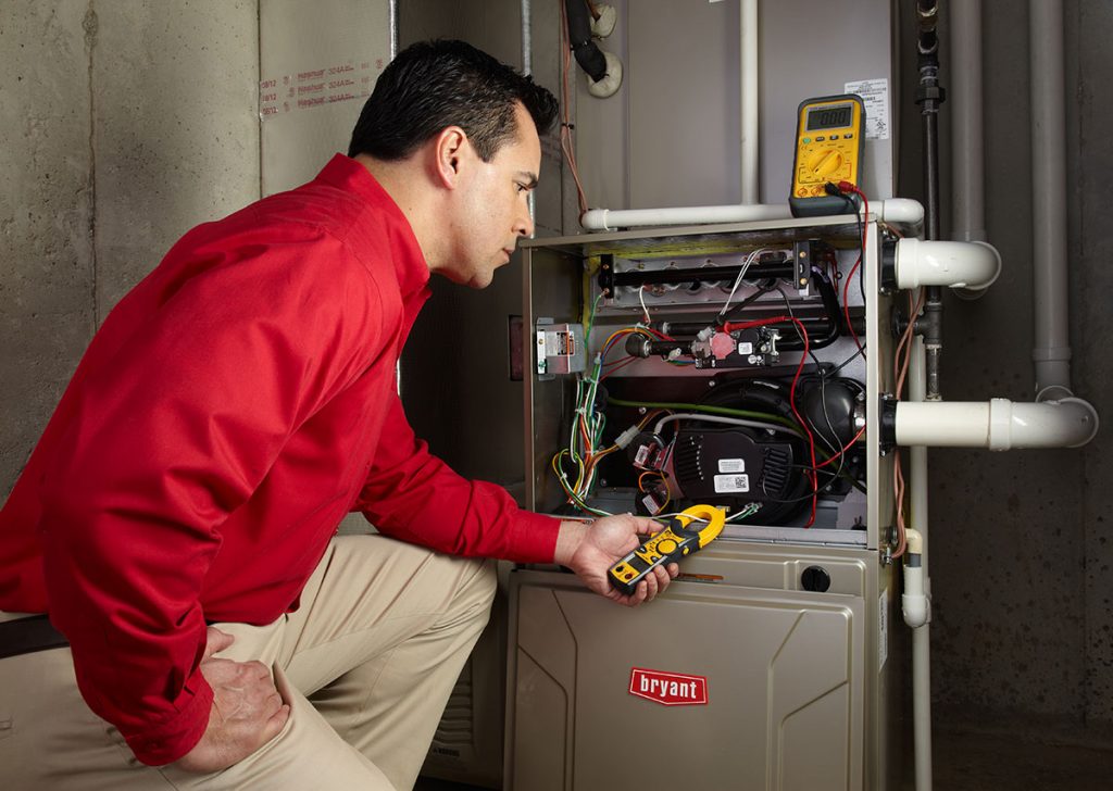 HVAC technician repairing an indoor furnace in Surprise