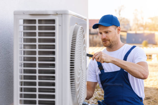 HVAC technician servicing an outdoor air conditioning unit in Surprise