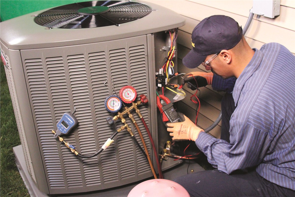 HVAC technician testing an outdoor air conditioning unit in Surprise